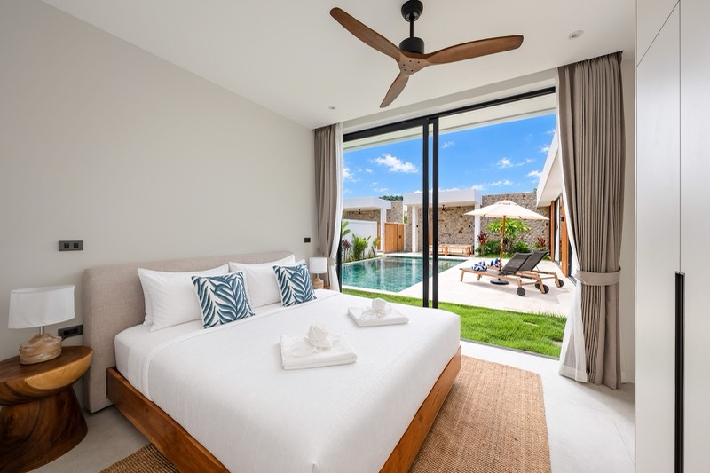 Bedroom with sliding doors opening onto the pool deck